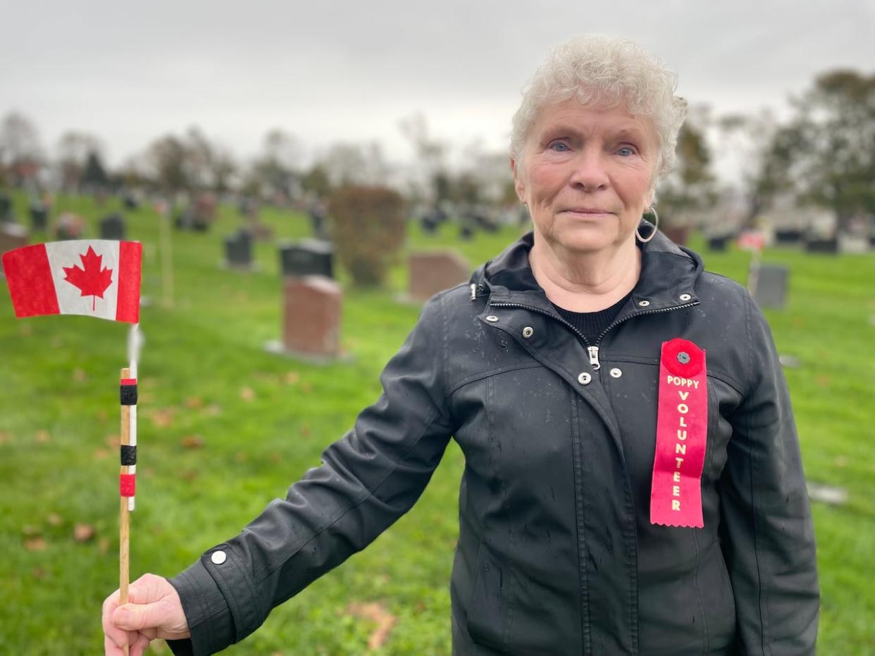 Gayle Mueller, a veteran and vice-president of the Summerside Legion, puts up hundreds of Canadian flags at veterans' gravesites every year around Remembrance Day.  (Steve Bruce/CBC - image credit)