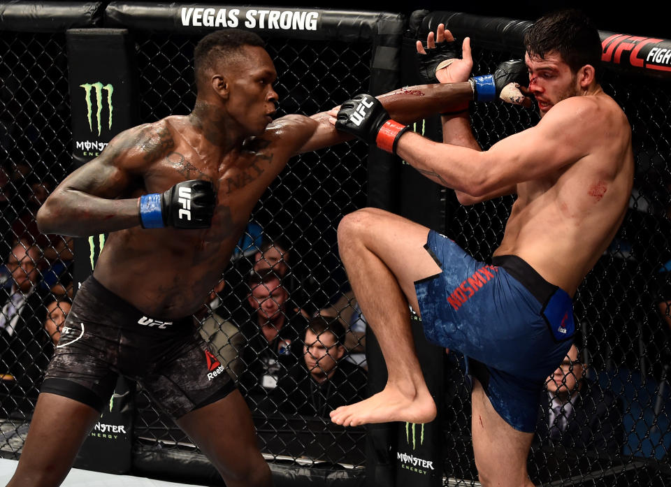 Israel Adesanya of Nigeria punches Rob Wilkinson of Australia in their middleweight bout during the UFC 221 event at Perth Arena on February 11, 2018 in Perth, Australia. (Photo by Jeff Bottari/Zuffa LLC/Zuffa LLC via Getty Images)