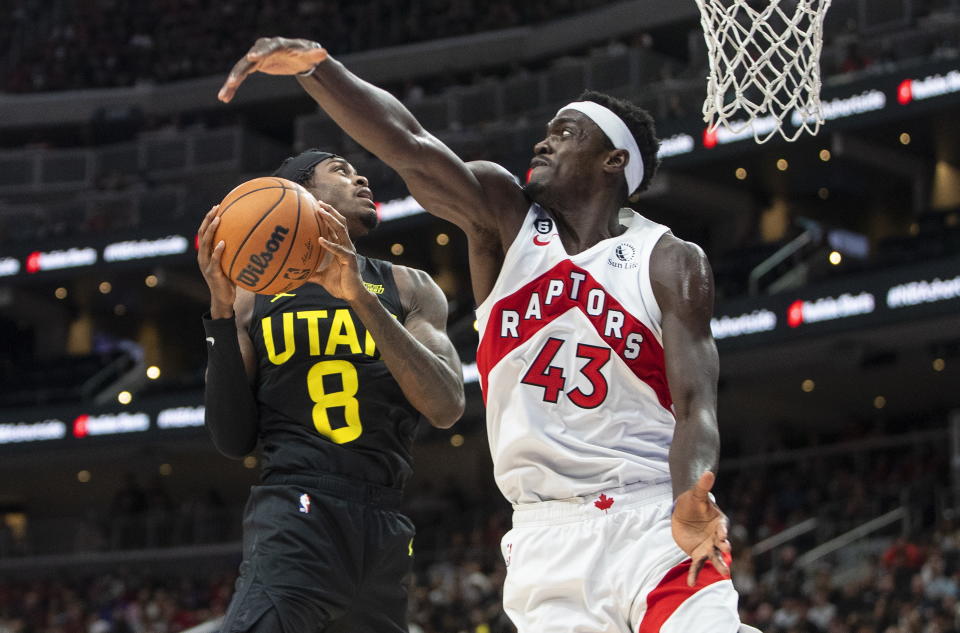 Utah Jazz's Jarred Vanderbilt (8) is blocked by Toronto Raptors' Pascal Siakam (43) during first-half preseason NBA basketball game action in Edmonton, Alberta, Sunday, Oct. 2, 2022. (Jason Franson/The Canadian Press via AP)