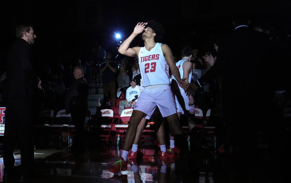 Fishers Tigers forward Keenan Garner (23) walks onto the court Friday, Feb. 9, 2024, during team introductions at Fishers High School in Fishers. The Fishers Tigers defeated the Cathedral Fighting Irish, 56-51.