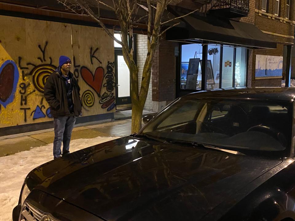 Kenosha resident Leonard Bolton watches his car after in anticipation of civil unrest after the District Attorney announced he would not pursue charges against the police officers who shot Jacob Blake