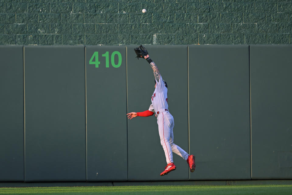 Boston Red Sox center fielder Jarren Duran cannot make the catch on a triple by Kansas City Royals' Kyle Isbel during the second inning of a baseball game Friday, Aug. 5, 2022, in Kansas City, Mo. (AP Photo/Reed Hoffmann)