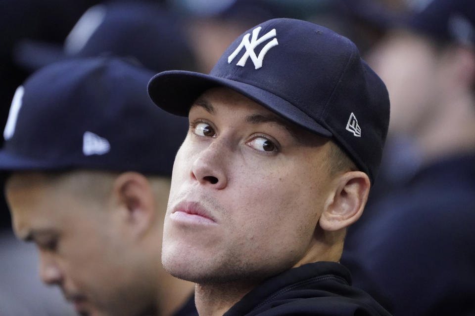 New York Yankees' Aaron Judge sits in the dugout during the third inning of a baseball game against the Texas Rangers in Arlington, Texas, Wednesday, Oct. 5, 2022. (AP Photo/LM Otero)