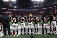 <p>Atlanta Falcons players lock arms during the national anthem before their game against the Buffalo Bills at Mercedes-Benz Stadium. Mandatory Credit: Jason Getz-USA TODAY Sports </p>