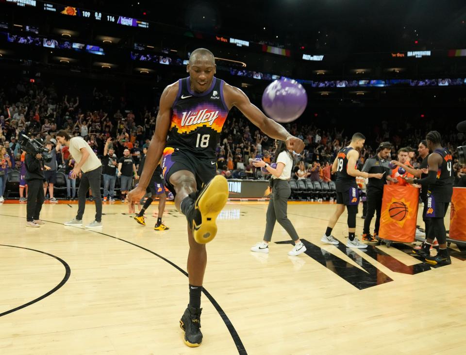 Apr 10, 2022; Phoenix, Ariz. U.S.;  Phoenix Suns center Bismack Biyombo (18) kicks a basketball to fans after their final regular season game at Footprint Center. They lost 116-109.