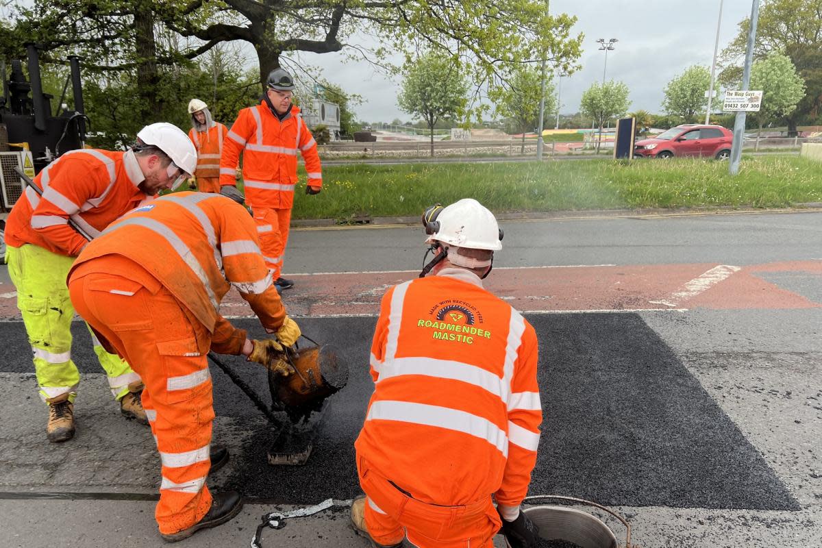 Workers demonstrating the effectiveness of mastic asphalt <i>(Image: Herefordshire Council)</i>
