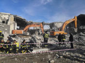 Emergency services clear the rubble of the house of Peshraw Dizayi that was hit in Iranian missile strikes in Irbil, Iraq, Tuesday, Jan. 16, 2024. Dizayi, a prominent local businessman, was killed in one of the Irbil strikes along with members of his family. (AP Photo/Julia Zimmermann/Metrography)