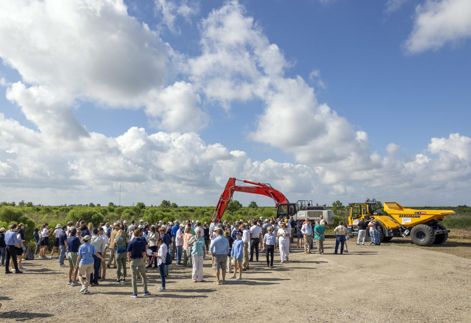 Public officials, staff with the Coastal Protection and Restoration Authority(CPRA), along with coastal rebuilding advocates from across south Louisiana, gather at the area where the Mid-Barataria Sediment Diversion will be built during a groundbreaking ceremony south of Belle Chasse, La., Thursday, Aug. 10, 2023. Nearly $3 billion in settlement money from the BP Deepwater Horizon disaster that devastated the Gulf Coast and killed hundreds of thousands of marine animals is now funding a massive ecosystem restoration in southeastern Louisiana’s Plaquemines Parish. (Chris Grange/The Times-Picayune/The New Orleans Advocate via AP)