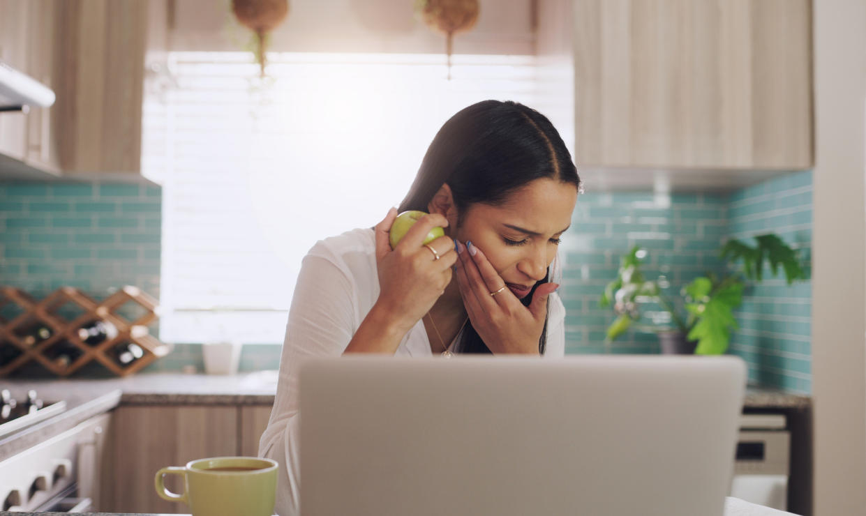 Woman struggling with toothache. (Getty Images)