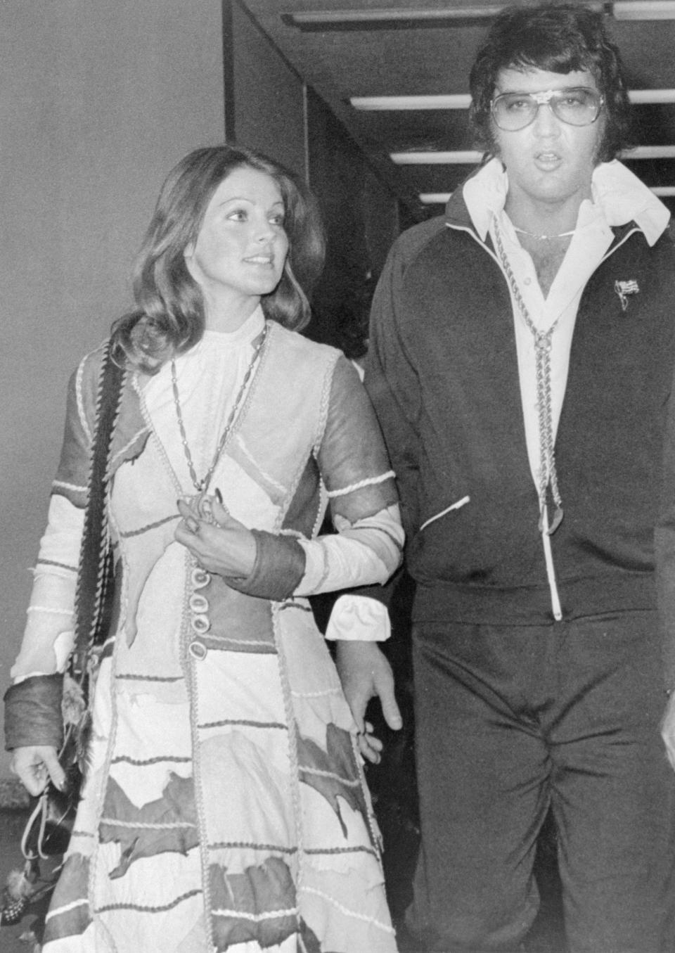 Priscilla and Elvis walking together