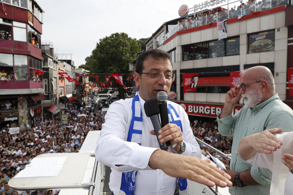 Ekrem Imamoglu, candidate of the secular opposition Republican People's Party, or CHP, acknowledges his supporters from atop his campaign bus, during a rally in Istanbul, Friday, June 21, 2019, ahead of June 23 re-run of Istanbul elections. The 49-year-old candidate won the March 31 local elections with a slim majority, but after weeks of recounting requested by the ruling party, Turkey's electoral authority annulled the result of the vote, revoked his mandate and ordered the new election.(AP Photo/Lefteris Pitarakis)