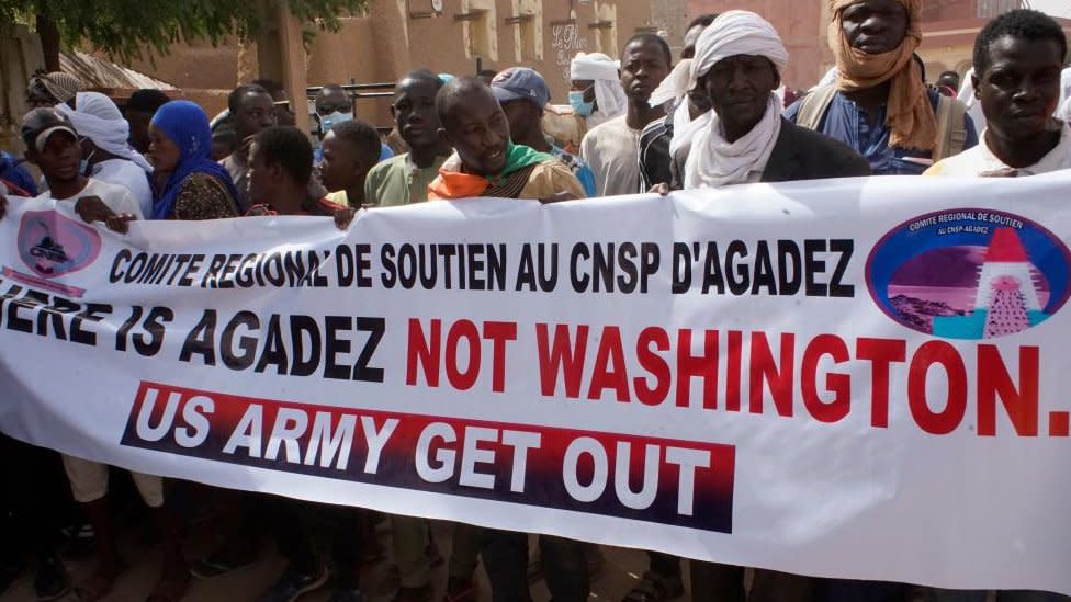 Demonstrators hold a banner during a protest rally to demand the withdrawal of US troops from Niger, in Agadez, 21 April 2024.