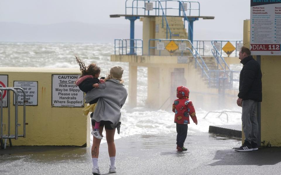 People look out at the waves in Salthill, Galway