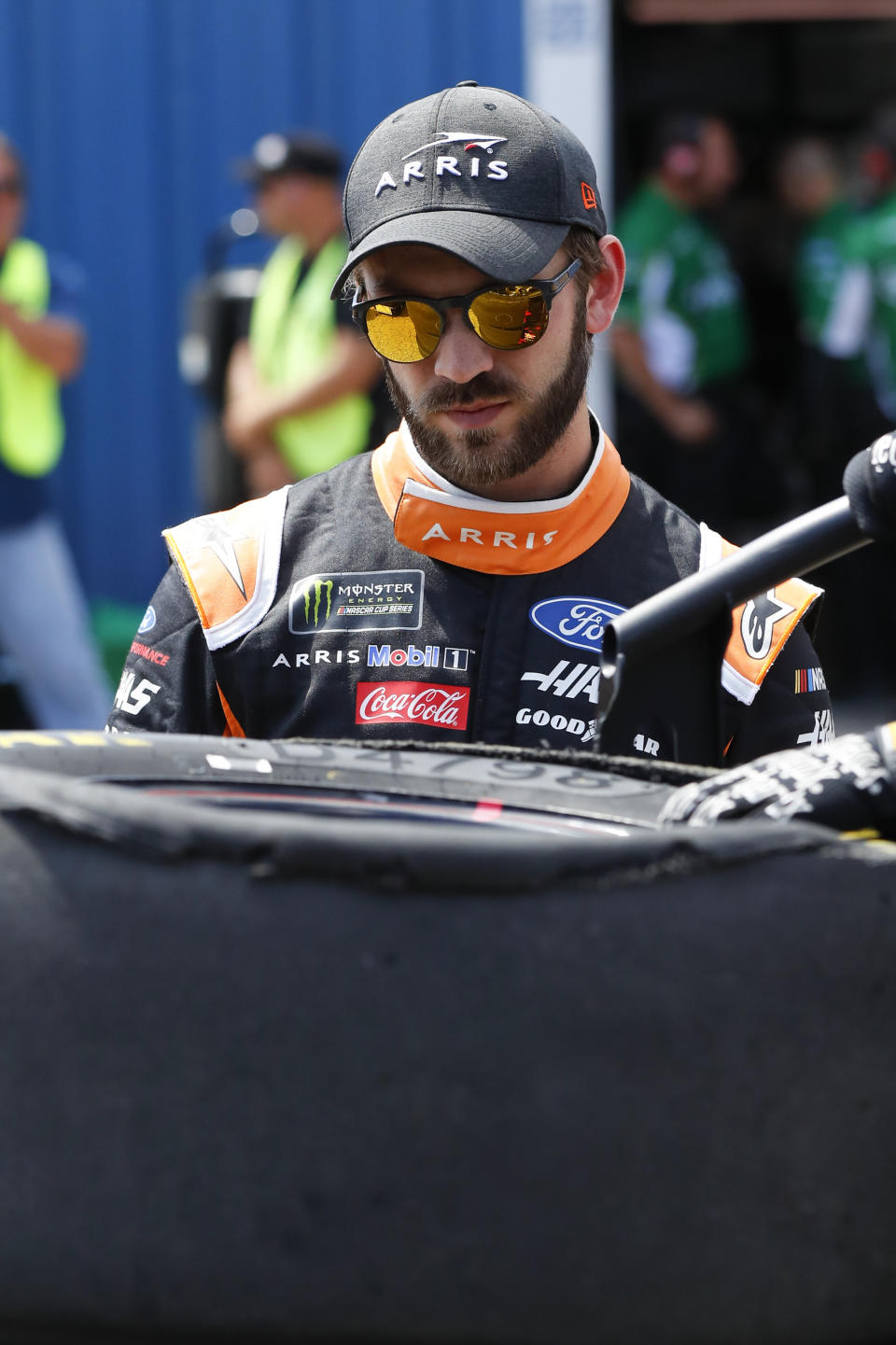 Daniel Suarez looks at his tire damage during practice for a NASCAR Cup Series auto race at Michigan International Speedway in Brooklyn, Mich., Saturday, Aug. 10, 2019. (AP Photo/Paul Sancya)