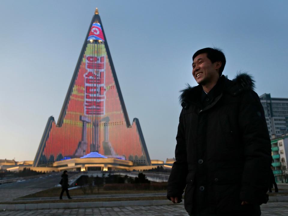 Designer Kim Yong Il stands next to his light show on the facade of the Ryugyong Hotel.