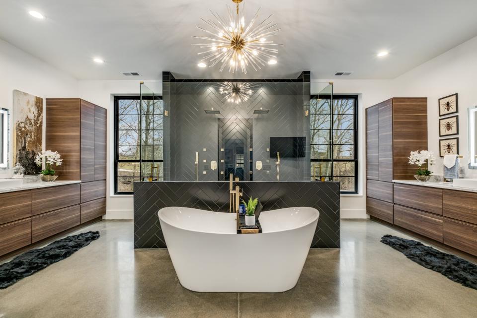 The primary bath at 259 Flynn Road in Gallatin features a soaking tub, large shower with double rain heads, and double marble vanities with extra counter space.