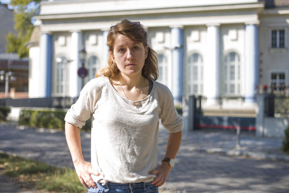 Naomi Henkel-Guembel poses for a portrait in front of the synagogue at the Fraenkelufer in Berlin, Germany, Wednesday, Sept. 23, 2020. Naomi Henkel-Guembel survived the anti-Semitic attack on the synagogue in the city of Halle in central Germany Yom Kippur in 2019. (AP Photo/Markus Schreiber)