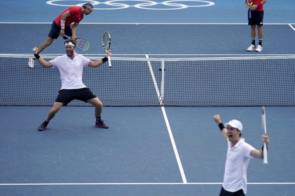 The New Zealand doubles team of Michael Venus, left, and Marcus Daniell react after defeating the team from the United States during the men's doubles bronze medal match of the tennis competition at the 2020 Summer Olympics, Friday, July 30, 2021, in Tokyo, Japan. (AP Photo/Seth Wenig)