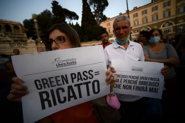 Protestors take part in a demonstration against the introduction of a mandatory 'green pass', in Piazza del Popolo in Rome, on July 28, 2021. - Italy on July 22 said a health pass would be mandatory for people wishing to access bars, restaurants, swimming pools, sports facilities, museums and theatres from August 6. (Photo by Filippo MONTEFORTE / AFP) (Photo by FILIPPO MONTEFORTE/AFP via Getty Images) (Photo: FILIPPO MONTEFORTE via Getty Images)