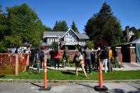 Media gather outside of the home of Huawei Technologies Chief Financial Officer Meng Wanzhou prior to a court hearing in Vancouver