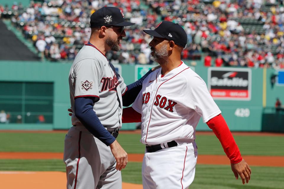 Red Sox manager Alex Cora, right, and Twins manager Rocco Baldelli exchange greetings for the series opener on Friday.