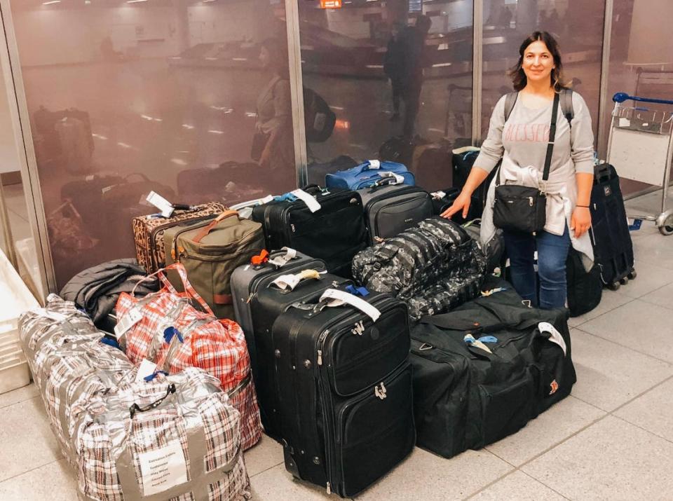 Bucks County resident Nataliya Pristatsky stands beside the bags of supplies that traveled with her and her husband, Pavlo Pristatsky, during their trip in March 2022 to Poland. Their mission was to help Ukrainian citizens crossing the border seek refuge in neighboring countries.