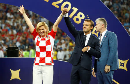 Soccer Football - World Cup - Final - France v Croatia - Luzhniki Stadium, Moscow, Russia - July 15, 2018 President of Croatia Kolinda Grabar-Kitarovic, President of France Emmanuel Macron and Croatian Football president Davor Suker on the stage before the presentation REUTERS/Kai Pfaffenbach