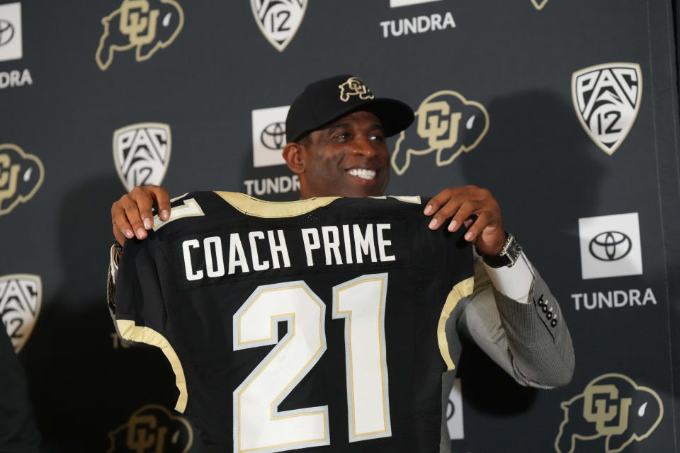 Deion Sanders displays a Colorado jersey after being introduced as the CU football coach last December.