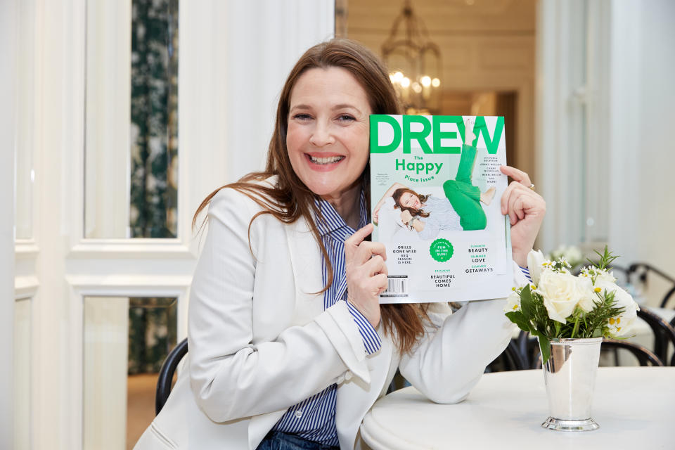 Drew Barrymore in white shirt holding Drew Magazine