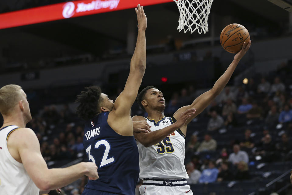 Denver Nuggets' PJ Dozier goes up to the basket against Minnesota Timberwolves' Karl-Anthony Towns in the second half of an NBA basketball game Monday, Jan. 20, 2020, in Minneapolis. Denver won 107-100. (AP Photo/Stacy Bengs)