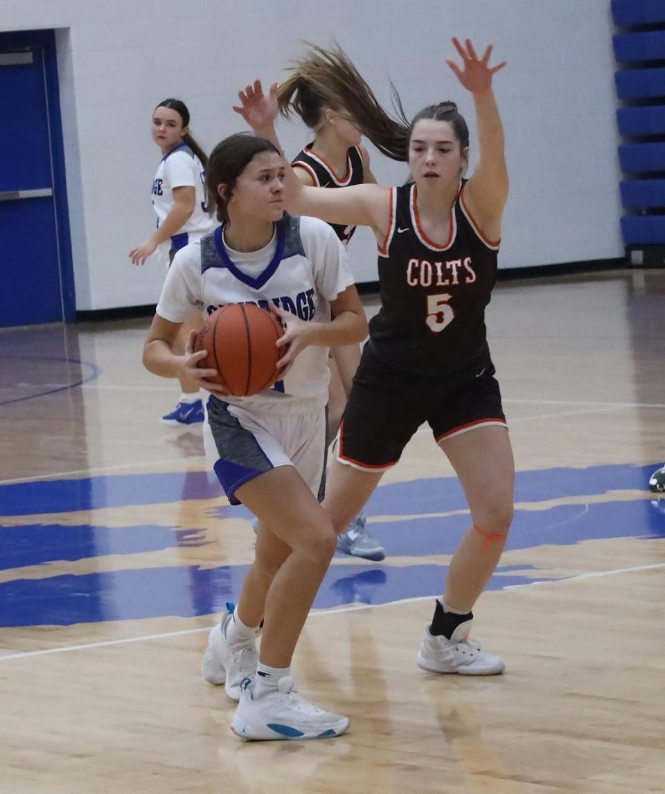 Meadowbrook senior Maddie May (5) pressures Cambridge freshman Miranda Cole (2) in a game from earlier this season. The Colts and Bobcats learned their tournament draws on Sunday.