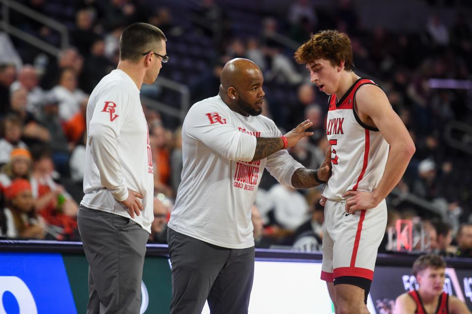 Brandon Valley’s assistant coach Darieon Smith talks to Brandon Valley's guard Landon Dulaney (5) on the sidelines on Thursday, March 14, 2024 at Denny Sanford Premier Center in Sioux Falls.