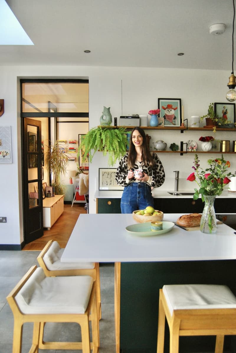 A dweller poses for a portrait in their kitchen.