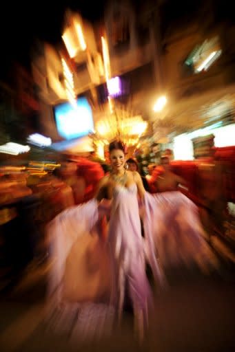 A Thai ladyboy is seen here outside a cabaret off Bangla road on Patong Beach, on the western coast of Phuket Island, southern Thailand. Gay and 'katoey' (transsexual) culture is visible and widely tolerated in Thailand, which has one of the largest transsexual populations in the world, and Natee said the temple's programme is "very out of date"