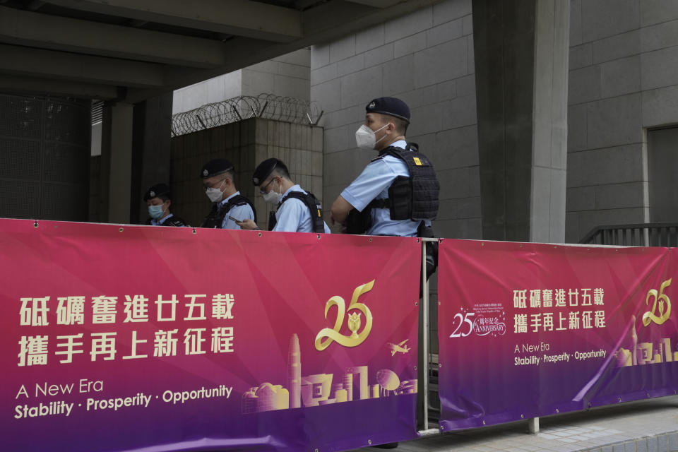 Police officers stand guard outside the high speed train station for the Chinese president Xi Jinping's visit to mark the 25th anniversary of Hong Kong handover to China, in Hong Kong, Thursday, June 30, 2022. (AP Photo/Kin Cheung)