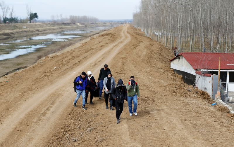 A group of migrants walk through the Turkish-Greek border in a village Bosnakoy near the border city of Edirne