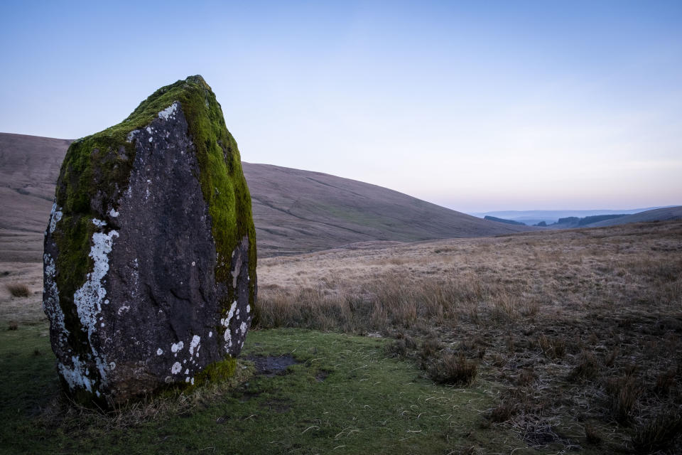 Maen Llia, an ancient standing stone in the Llia valley, Brecon Beacons, Powys, South Wales. The stone is a massive sandstone block which stands 3.7m high. It is roughly diamond-shaped and is partly moss-covered. Its age and original purpose are unknown though it is thought to date from the Bronze Age. It is a popular tourist attraction run by Brecon Beacons National Park.  (photo by Andrew Aitchison / In pictures via Getty Images)