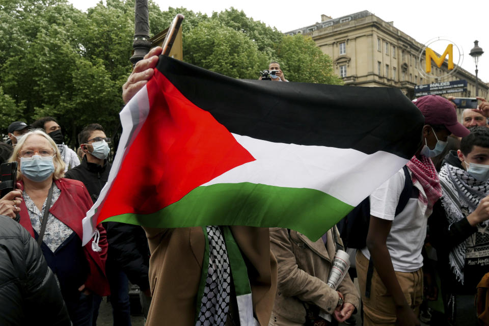 A protester waves a flag during a protest in solidarity with Palestinians, in Paris, Wednesday, May 12, 2021. (AP Photo/Thibault Camus)
