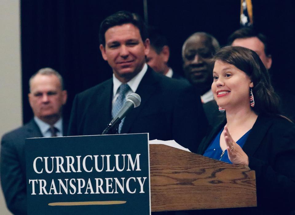 Rebecca Sarwi, a member of Moms for Liberty speaks next to Gov. Ron DeSantis at a press conference held at Embry-Riddle Aeronautical University in Daytona Beach on March 25.