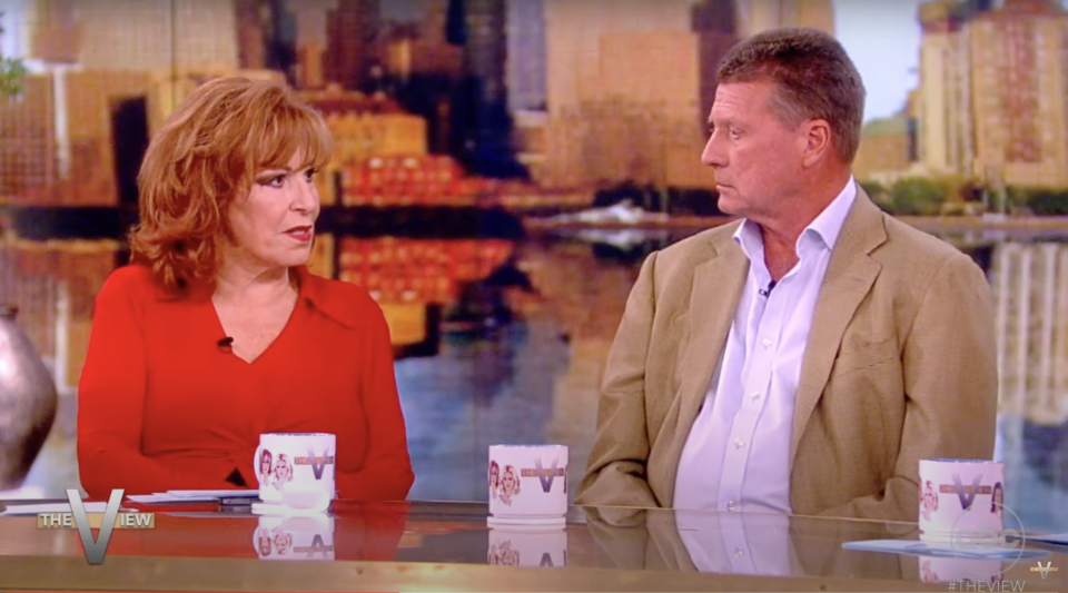 Joy Behar and guest in conversation on 'The View' set with cityscape background
