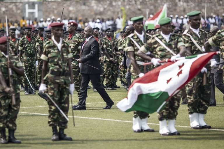 Burundi President Pierre Nkurunziza (C) reviews troops after arriving for the celebrations marking the 53rd anniversary of the country's Independence at the Prince Rwagasore stadium in Bujumbura on July 1, 2015