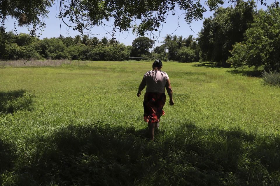 Maria Dolores Garcia, the mother of Esmeralda Dominguez, walks to her daughter’s unattended garden, in the Sisiguayo community in Jiquilisco, in the Bajo Lempa region of El Salvador, Thursday, May 12, 2022. Her daughter is among the thousands arrested by El Salvador security forces in the past eight weeks since the congress granted President Nayib Bukele a state of emergency declaration suspending some civil liberties. (AP Photo/Salvador Melendez)