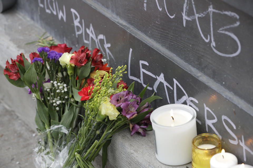 Flowers and candles are shown at a growing memorial, Saturday, June 20, 2020, at the intersection of 10th Ave. and Pine St. near the Capitol Hill Occupied Protest zone in Seattle where a pre-dawn shooting near the area left one person dead and critically injured another person, authorities said Saturday. The area has been occupied by protesters after Seattle Police pulled back from several blocks of the city's Capitol Hill neighborhood near the Police Department's East Precinct building. (AP Photo/Ted S. Warren)