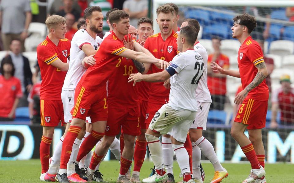 Wales' defender Chris Mepham (CL) pushes Albania's midfielder Amir Abrashi (CR) away from a melee during the international friendly football match between Wales and Albania at Cardiff City Stadium in Cardiff, South Wales, on June 5, 2021.  - GETTY IMAGES