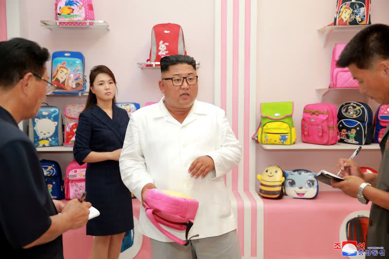 North Korean leader Kim Jong Un and his wife Ri Sol Ju inspect the Wonsan Disabled Soldiers' Bag Factory