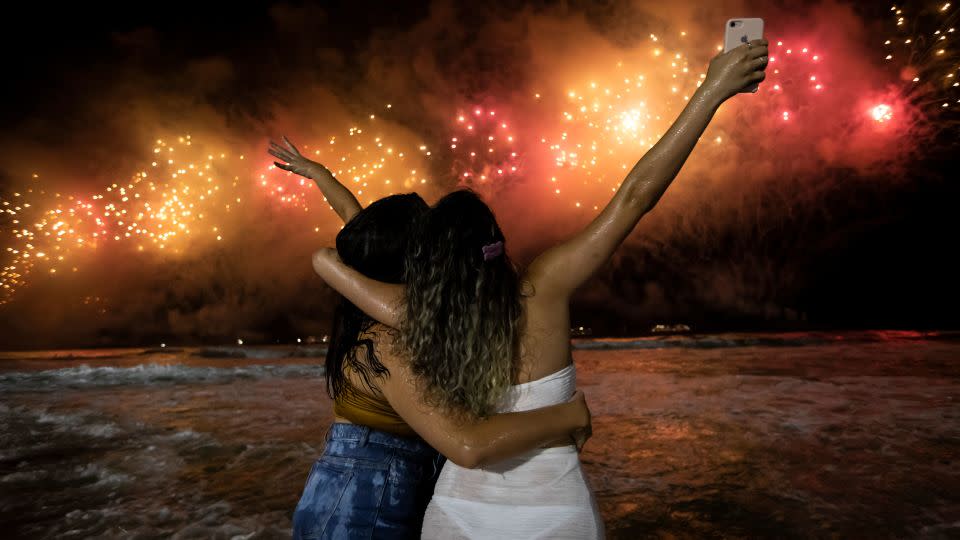 People bring in the New Year as they watch fireworks explode over Copacabana Beach in Rio de Janeiro, Brazil, early Sunday, Jan. 1, 2023. - Bruna Prado/AP