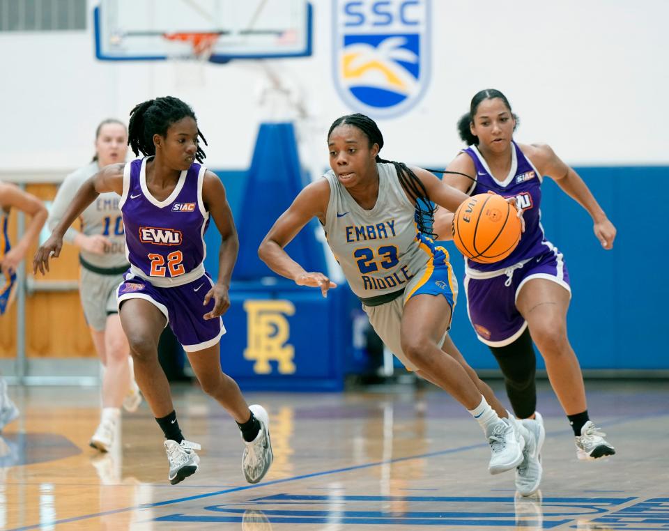 Embry-Riddle's Madyson Jean-Louis (23) attempts to drive down court past Edward Waters' Sha'Kawanza Brown during a game at Embry-Riddle Aeronautical University in Daytona Beach, Friday, Dec.15, 2023.
