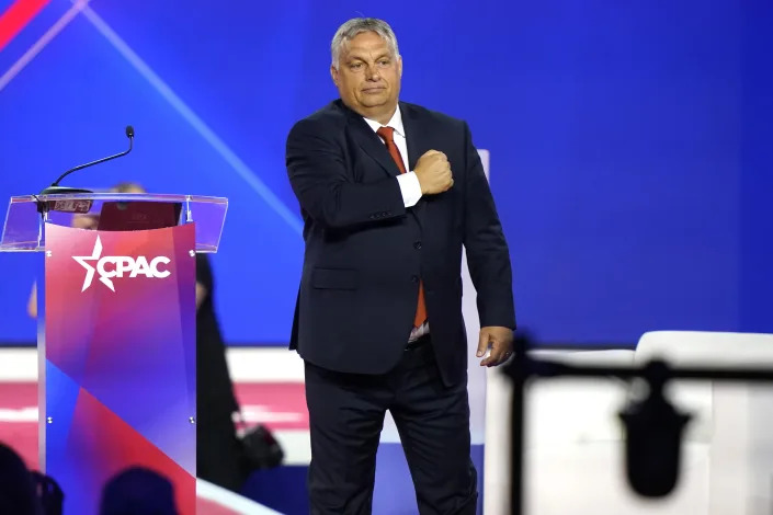 Hungarian Prime Minister Viktor Orbán gestures with his fist on his chest.