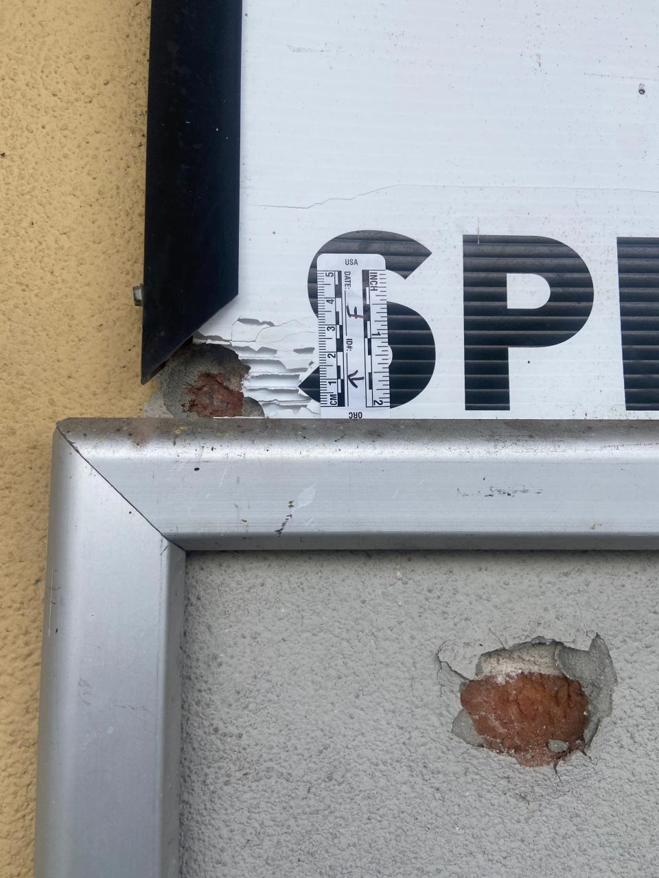 Bullet holes at Half Time Liquors from Saturday's mass shooting are labeled on the wall on Monday, Oct. 31, 2022.