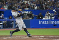 New York Yankees' Aaron Judge hits a two-run home run, his 61st homer of the season, during the seventh inning of the team's baseball game against the Toronto Blue Jays on Wednesday, Sept. 28, 2022, in Toronto. (Nathan Denette/The Canadian Press via AP)